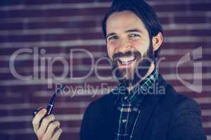 Portrait of happy man smoking pipe