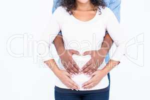 Midsection of couple with hands on belly