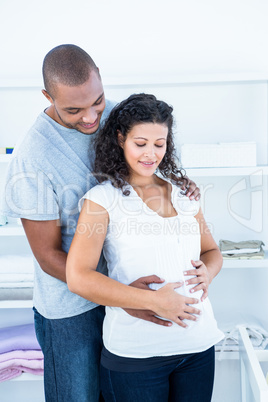 Husband touching pregnant wife belly