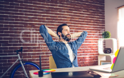 Thoughtful businessman relaxing in creative office