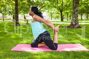 Young woman doing yoga on mat