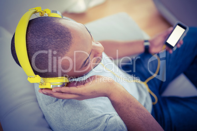 High angle view of man listening music