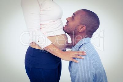 Happy man with pregnant woman against white backgrounfd