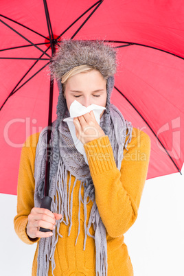 Woman blowing her nose with a tissue