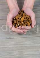 Woman showing handful of almonds