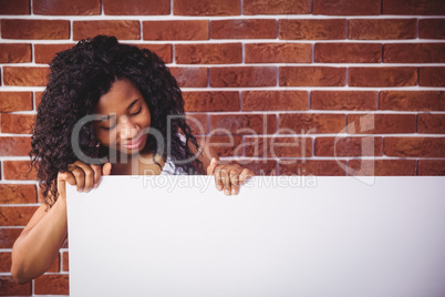 Smiling woman holding white board