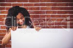 Smiling woman holding white board