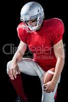American football player with hand on knee
