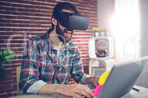 Happy creative businessman wearing 3D video glasses at office