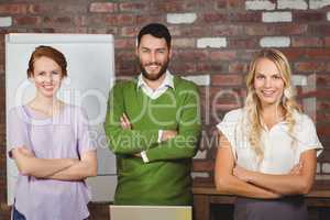 Portrait of happy business colleagues with arms crossed