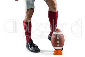 Low section of sportsman kicking ball