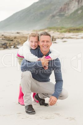 Father crouching with daughter behind him