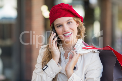 A smiling woman using her phone