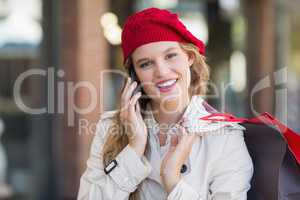 A smiling woman using her phone