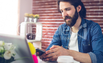 Creative businessman using mobile phone