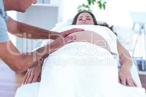 Masseur providing massage to pregnant woman