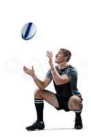 Full length of rugby player catching the ball