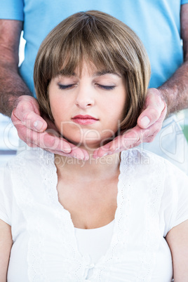 Calm woman receiving reiki from male therapist Calm woman receiving reiki from male therapist