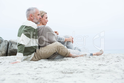 Cute couple sitting in the sand