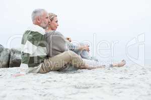 Cute couple sitting in the sand