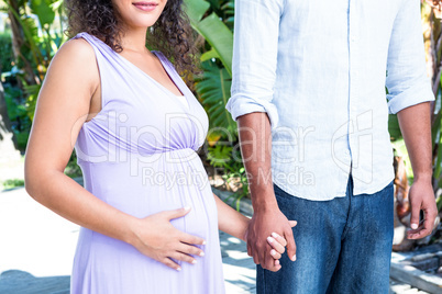 Midsection of husband with pregnant wife