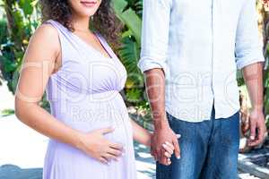 Midsection of husband with pregnant wife