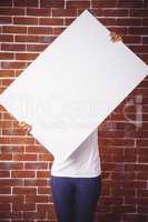 Woman holding up a white board