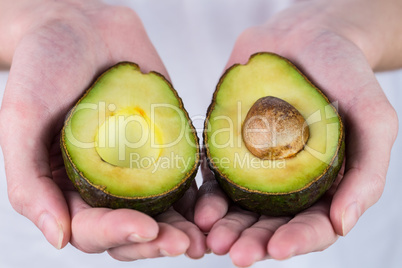 Woman showing fresh avocado