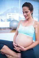 Pregnant woman resting in gym