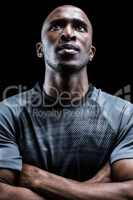 Close-up of thoughtful rugby player with arms crossed