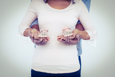 Midsection of couple carrying shoes