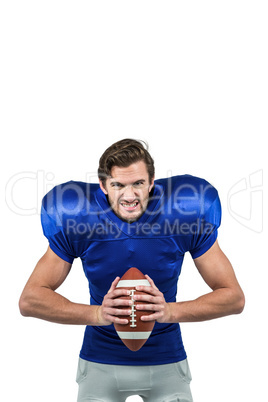 Aggressive american football player holding ball
