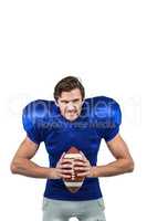 Aggressive american football player holding ball