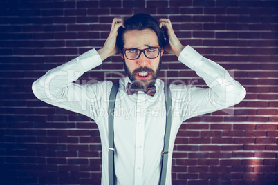 Portrait of angry man with head in hands