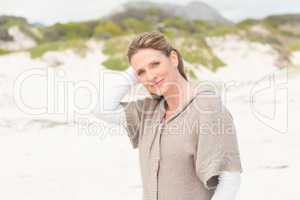 Smiling woman standing on the sand