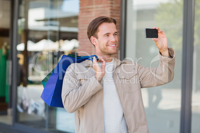 A smiling man taking a selfie