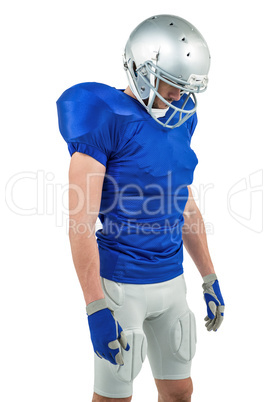 American football player looking down American football player looking down