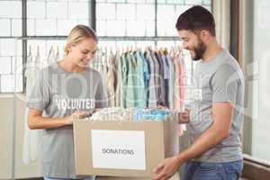 Happy volunteer looking at donation box