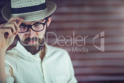 Portrait of confident hipster wearing eyeglasses and hat