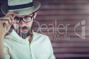 Portrait of confident hipster wearing eyeglasses and hat