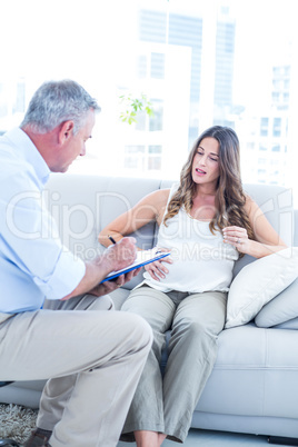 Psychiatrist advising preganant woman at home