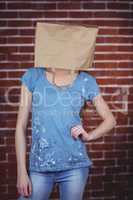 Woman posing with bag on head