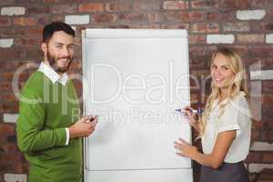 Portrait of smiling colleagues while preparing presentation