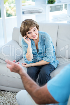 Portrait of smiling beautiful woman sitting on sofa