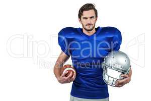 Confident american football player holding an helmet