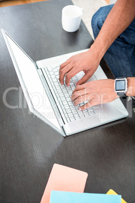 High angle view of man working on laptop