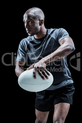 Determined rugby player in position to throw ball
