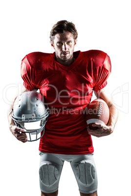 American football player in red jersey holding helmet and ball