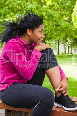 Fit woman sitting on bench