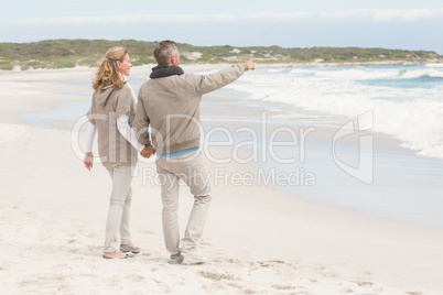 Happy couple holding hands while walking